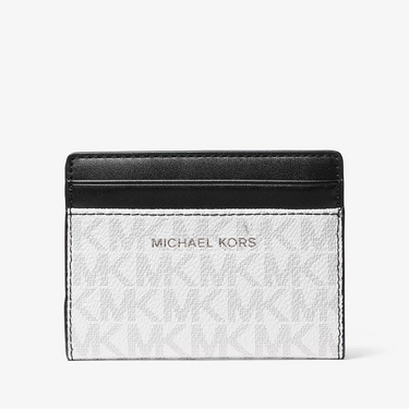 Michael Kors cardholder with black top section and white bottom section on a white background