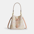 Coach Rowan Bucket Bag In Signature Canvas in Gold Chalk Pink